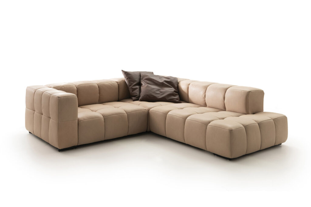 Sofakombination des Modells Lucy mit beigem Lederbezug, Wurfkissen und mattschwarzen Füssen